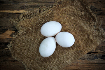 White eggs on an old wooden table