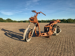 Fototapeta na wymiar rusty scooter in an empty field