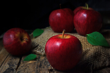 Red apples on an old wooden table