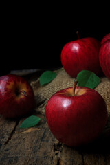 Red apples on an old wooden table