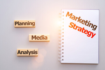 Planning marketing strategy. Top view close-up image, words written om wooden blocks