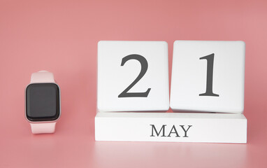 Modern Watch with cube calendar and date 21 may on pink background. Concept spring time vacation.