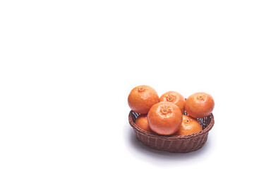 Basket with tangerines on a white background