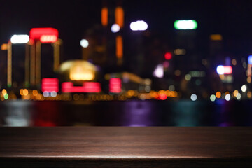 Empty wooden table space platform and blurred night city or dining background for product display montage