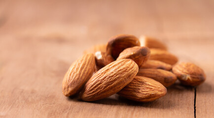 peeled almond  piece  Select focus  on wood table almond. Nuts Ready to use with advertising text
