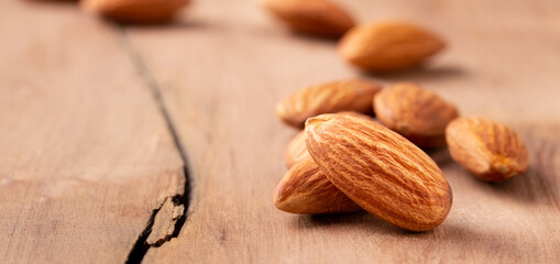peeled almond  piece  Select focus  on wood table almond. Nuts Ready to use with advertising text