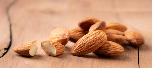side view Select focus peeled almond on wood table almond Nuts Ready to use with advertising text