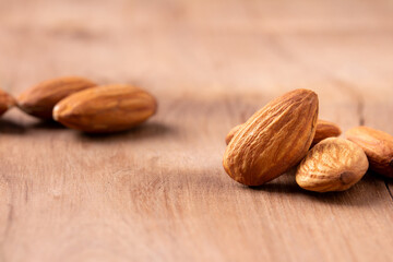 side view Select focus peeled almond on wood table almond Nuts Ready to use with advertising text
