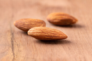 side view  peeled almond piece on wood table almond Nuts Ready to use with advertising text
