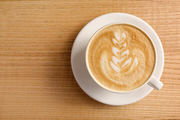 Cup of tasty coffee on wooden table