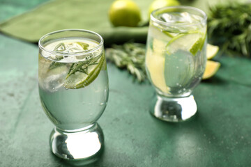Glasses of healthy cocktail on color background
