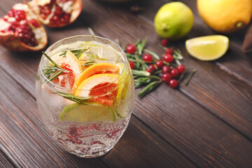 Glass of healthy cocktail on wooden background