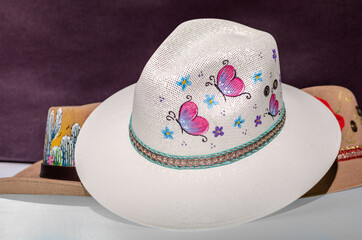 Sombrero decorado con  flores y mariposas pintadas