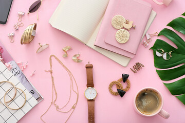 Beautiful jewelry with female accessories, cup of coffee and stationery on color background
