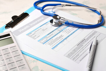 Health insurance form with stethoscope and calculator on light background