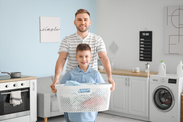 Man and his little son with laundry at home