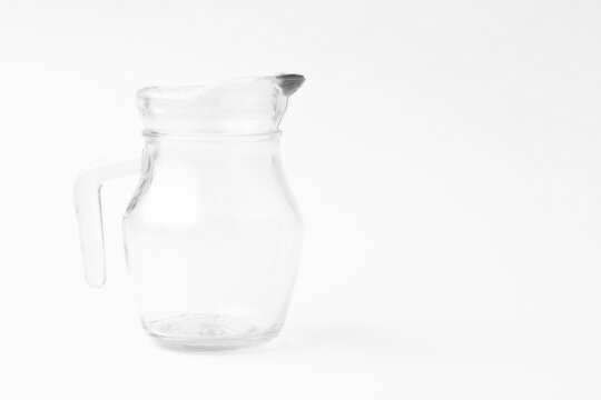empty glass jug on white background