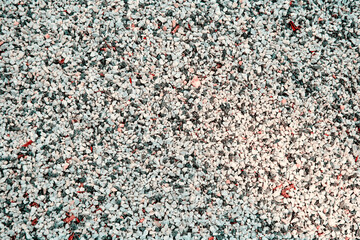 Small White, black, yellow pebble background. Top view of gravel stone texture