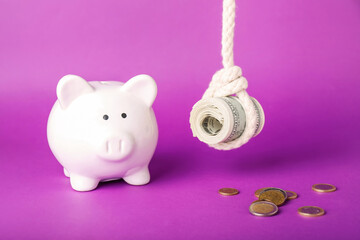 Piggy bank and money on color background. Concept of debt