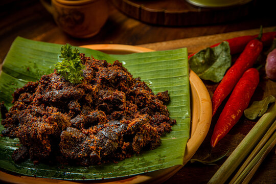 Rendang Paru or Spicy Beef Lung stew traditional food from Padang, Indonesia. The dish is arranged among the spices and herbs used in the original recipe like chili, lemongrass onion