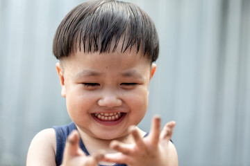 Happy Asian children playing outside with dirty hands