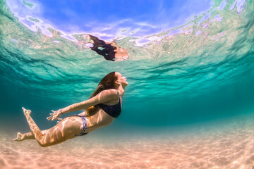 Young girl swimming in the crystal clear water, Bondi Beach, Australia