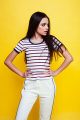 lifestyle people concept: pretty young school teenage girl having fun happy smiling on yellow background