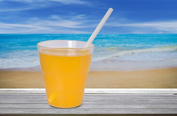glass of orange juice on the beach
