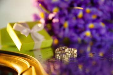 Bridal bouquet of irises, wedding rings. Wedding details. The morning of the bride. Marriage preparations