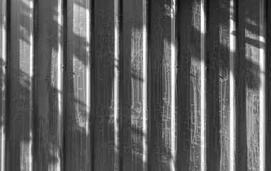 Obraz premium Lighting and shadow surface of metal sheet wall gray color Roof or wall made from zinc