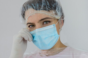 Nurse portrait with gloves and blue medical mask