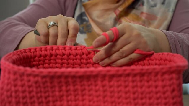 Close-up video of women doing stone painting, handicraft knitting and pattern work with local patterns.