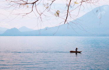 fisherman in his boat at the sunrise