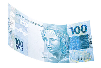 banknote of one hundred reais from brazil falling on isolated white background