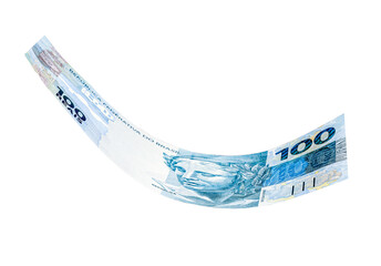 banknote of one hundred reais from brazil falling on isolated white background