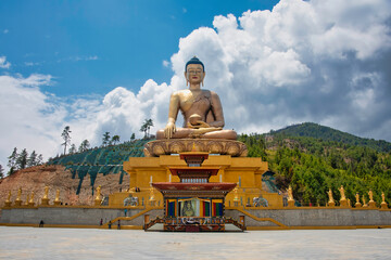 Buddha Dordenma, Thimpu, Bhutan – April 28, 2018 - gigantic Shakyamuni, golden statue of Buddha sitting atop a gilded meditation hall under a bright blue sky in the capital city of Bhutan
