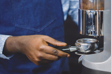 Fototapeta na wymiar Making coffee. Holder in the hands.