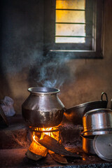 Traditional indian cooking inside the house over the fire in Kerala