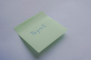 business concept of employee monthly payroll isolated handwritten on the green sticky postit note