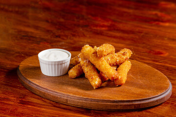 Potato chips, squid, shrimp, cheese sticks, with sauce,  beer snack on the table