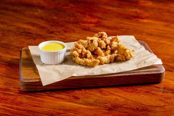 Potato chips, squid, shrimp, cheese sticks, with red sauce,  beer snack on the table