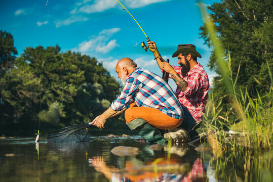 Hobby For Soul. Fly Fishing Hobby Of Men In Checkered Shirt. Fishing Requires To Be Mindful And Fully Present In Moment.Luxury Life Concept. Trout Bait. Retired Dad And Mature Bearded Son.