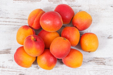 Apricot or peach on rustic board as healthy snack or dessert. Food containing vitamins and minerals