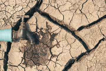 Faucets on dry ground drought and crisis environment.