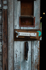 Shabby sign OPEN on the door. An old cafe with the inscription open on the door. Retro cafe and its door.