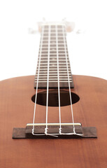 Ukulele, hawaiian guitar. soft focus on bridge.