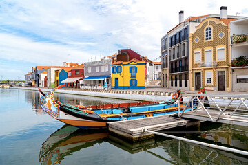 Fototapeta na wymiar Moliceiro boats docked along the central canal in Aveiro, called Portugal Venice