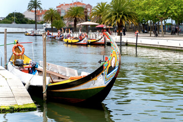 Fototapeta na wymiar Moliceiro boats docked along the central canal in Aveiro, called Portugal Venice