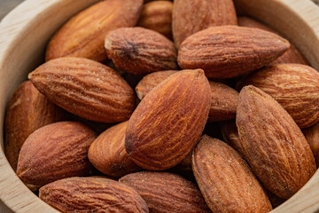 almond seeds on wooden table background, healthy food
