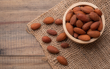 almond seeds on wooden table background, healthy food
